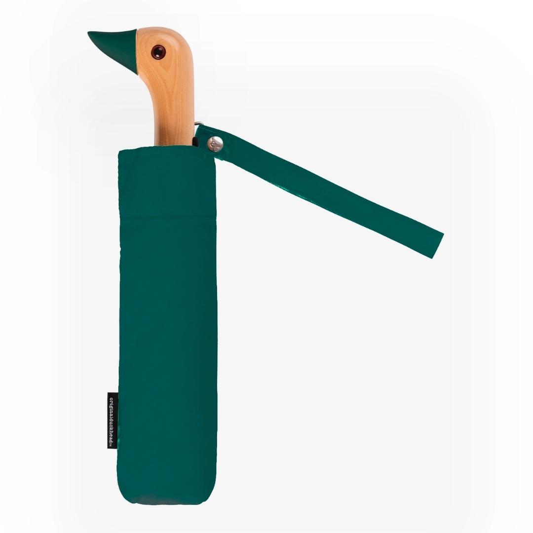 Compact umbrella in forest green with birchwood handle in the shape of duck head
