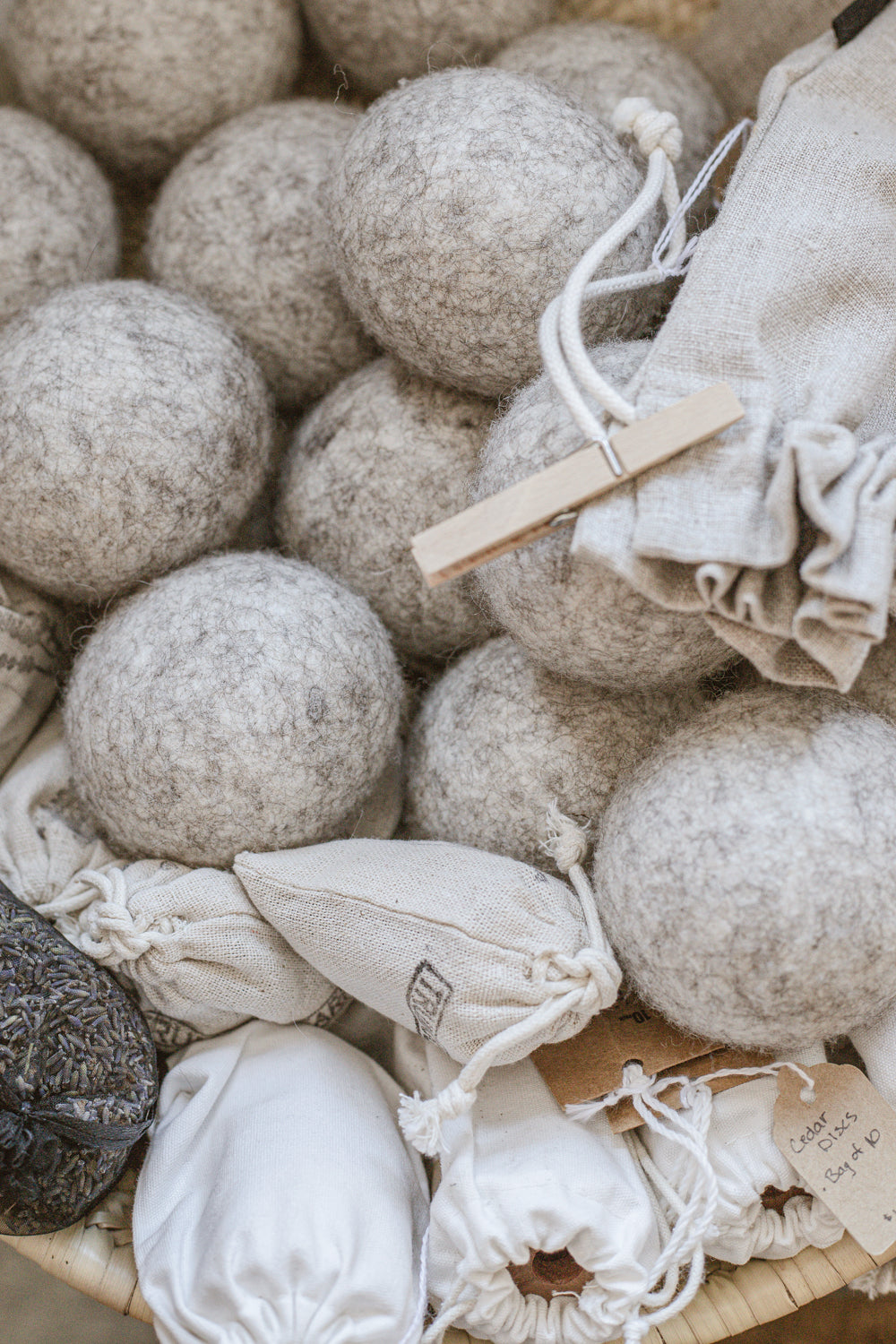 wool dryer balls, linen bag of wooden clothes pins, sachets of organic dried lavender, and cedar discs in drawstring bags