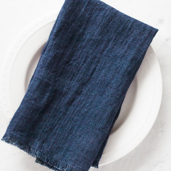 20-inch square stonewashed linen napkins with fringe edge shown in indigo