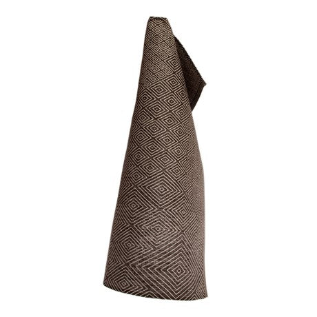 Linen tea towel in classic diamond pattern in black hanging on hook