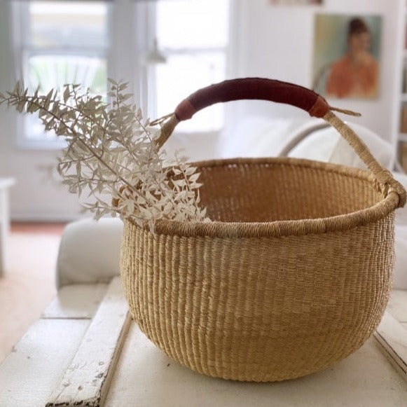 15-inch handwoven Bolga basket in natural color holding dried flowers