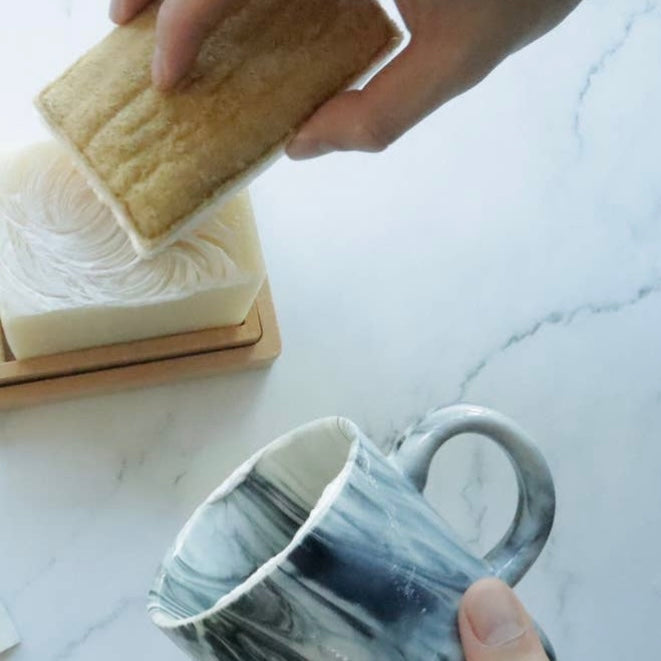 Cellulose Loofah Kitchen Sponge used cleaning a mug.