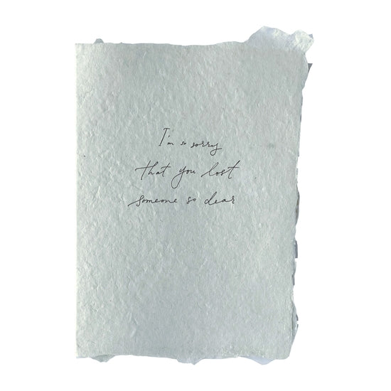 Handmade paper card with black letterpress ink, message on front reads: “I’m so sorry that you lost someone so dear" 