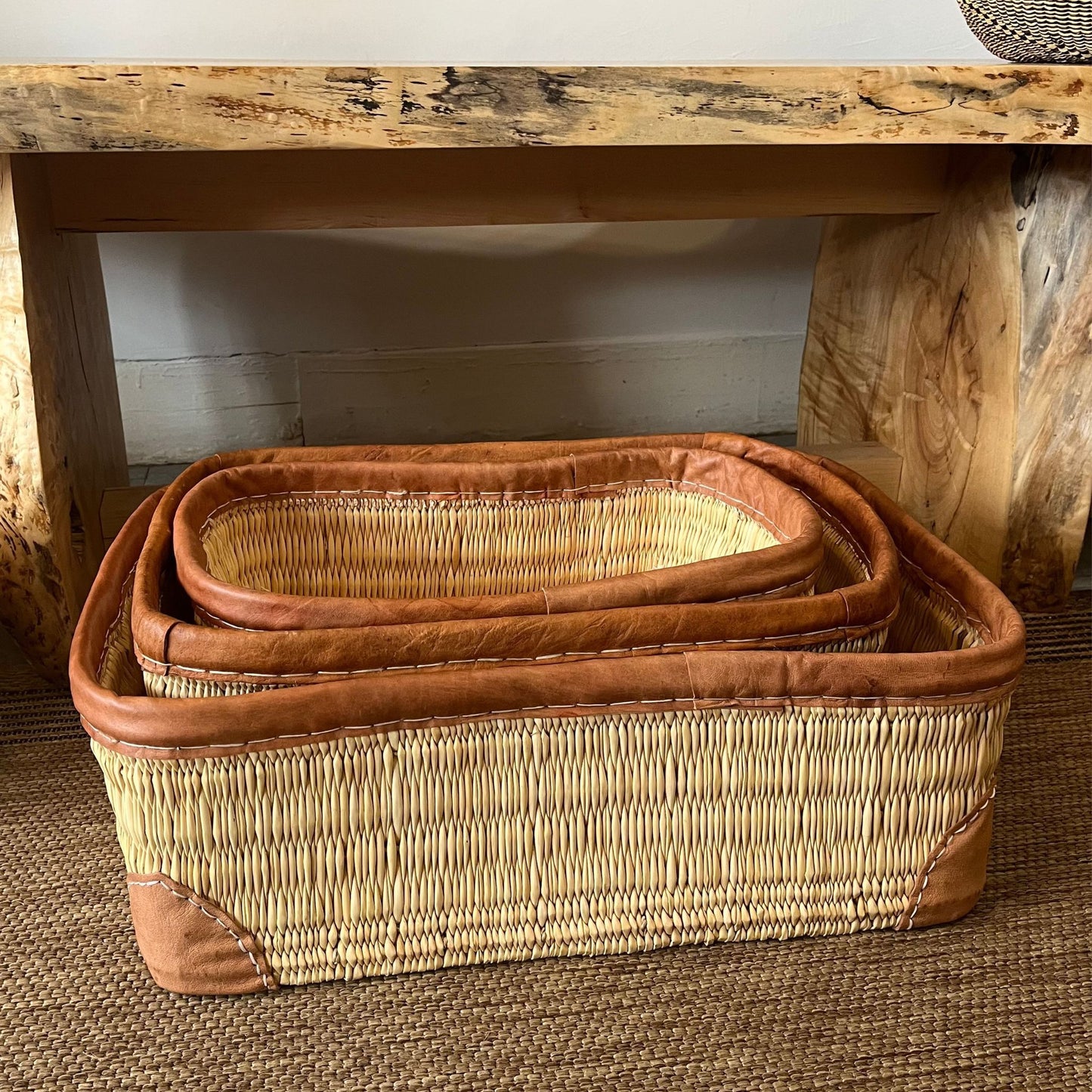Nested set of woven palm and leather-trimmed rectangular storage baskets