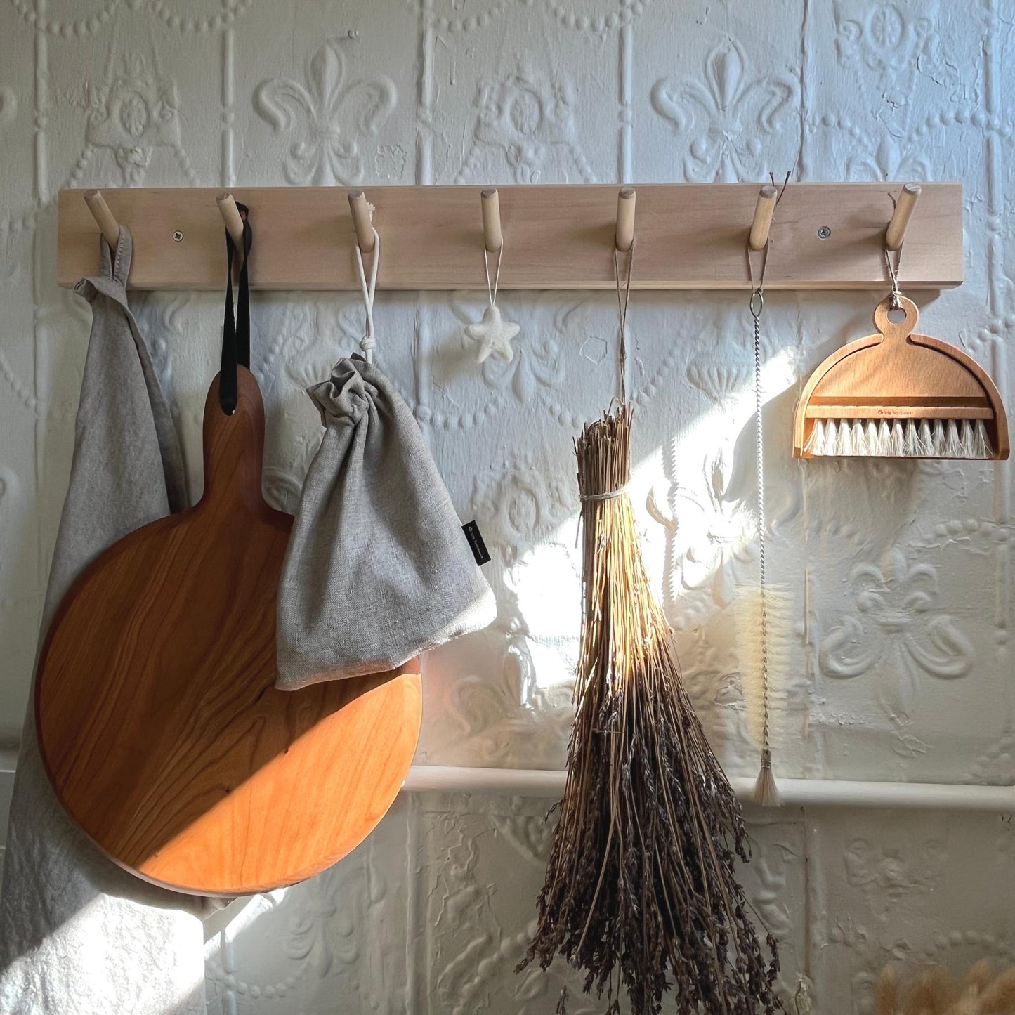 Handmade felted wool star hanging on wall hook rail