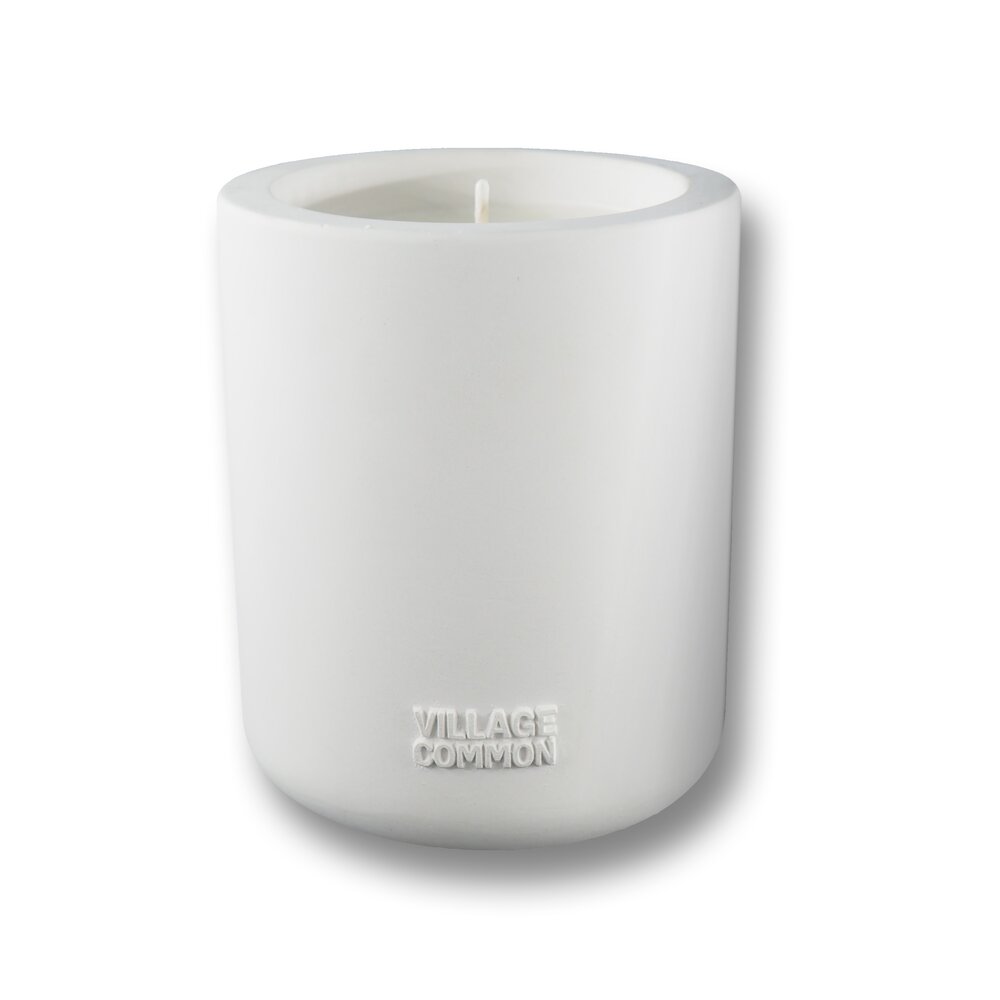 10-ounce soy and coconut wax candle with essential oils of bergamot, parsley, sage and vetiver inside a cream colored in concrete vessel