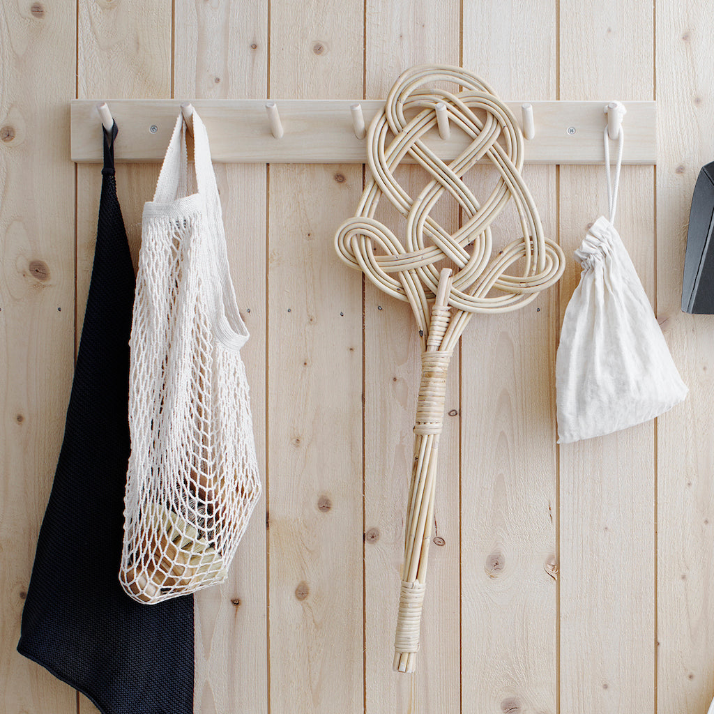 carpet beater hanging on a peg rail hook