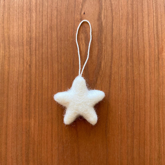 Handmade felted wool star ornament for decorating a holiday tree or adorning a gift