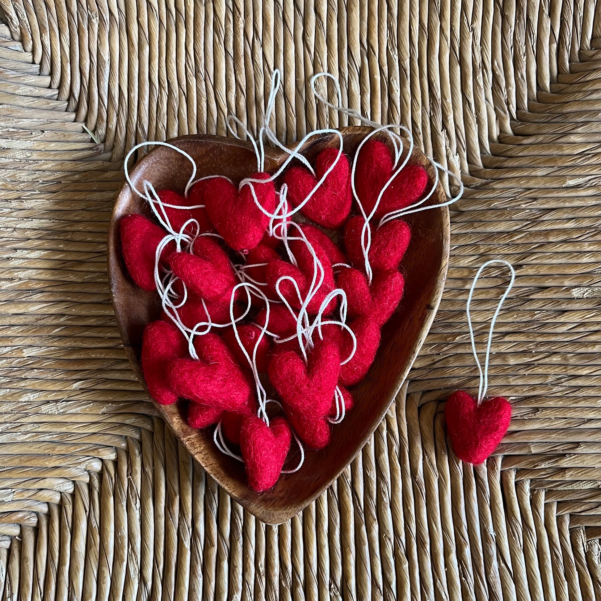 Handmade felted wool red hearts in heart-shaped bowl